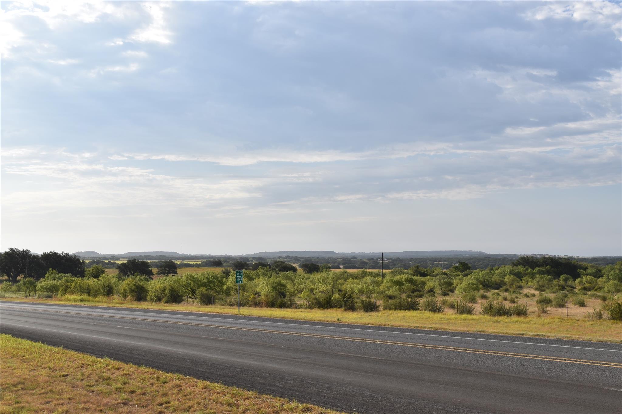 Distant hills rise above the rolling rural landsc