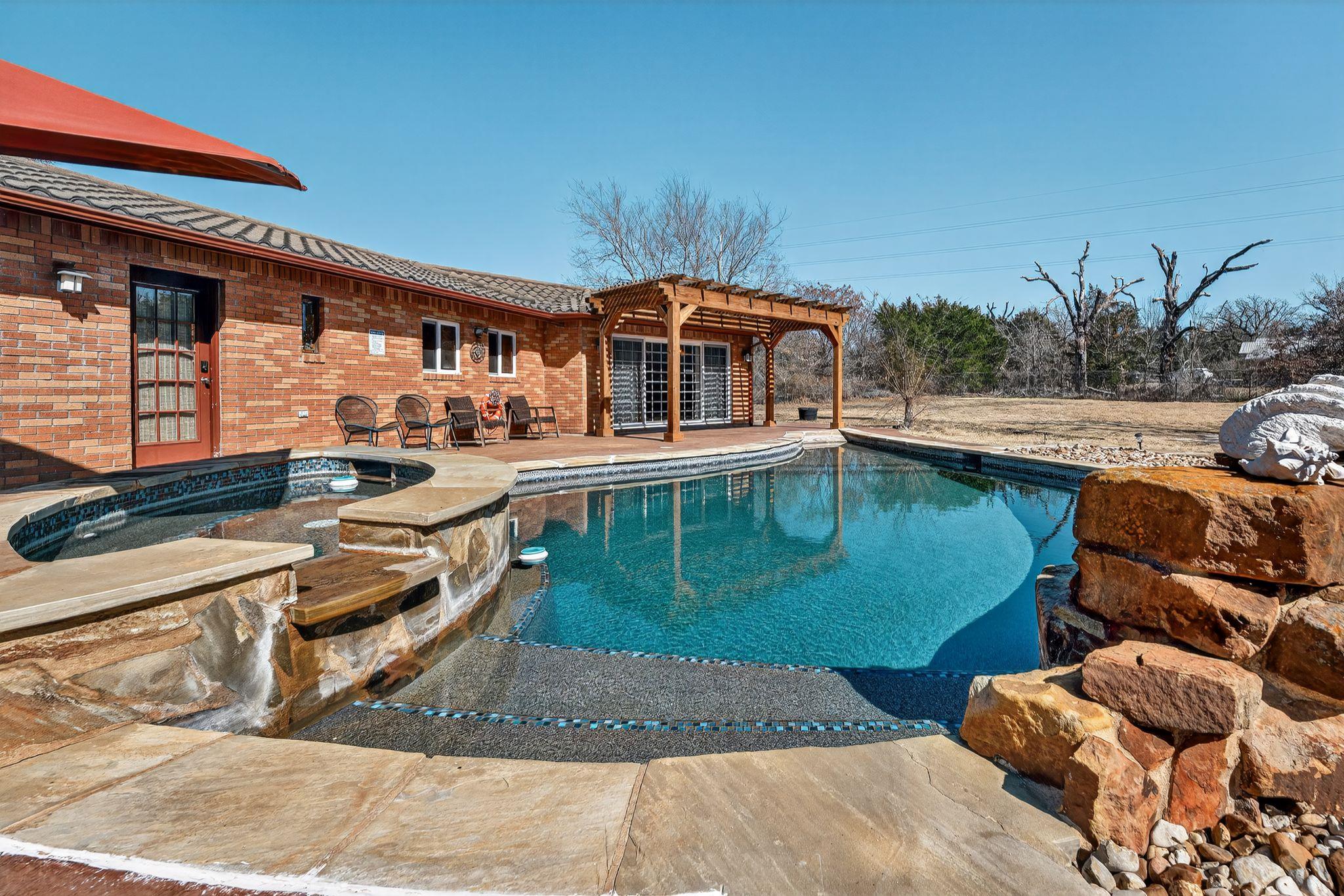 An inviting backyard oasis features a brick exter