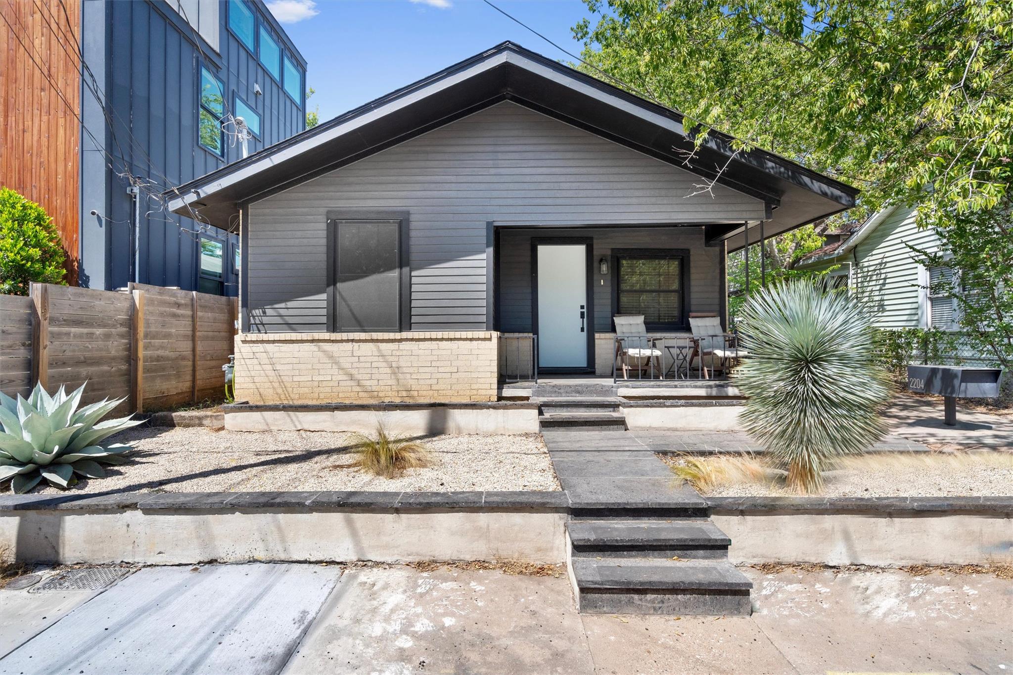 An inviting front porch welcomes guests to this m