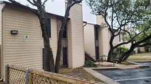 Mature trees shade a classic multi-family exterio