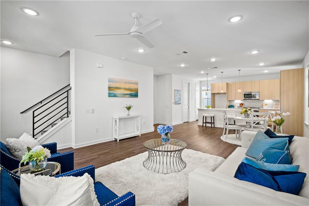 Living area with dark wood finished floors, ceili
