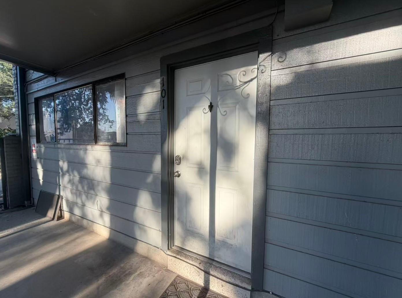 A sheltered concrete entryway introduces the stru