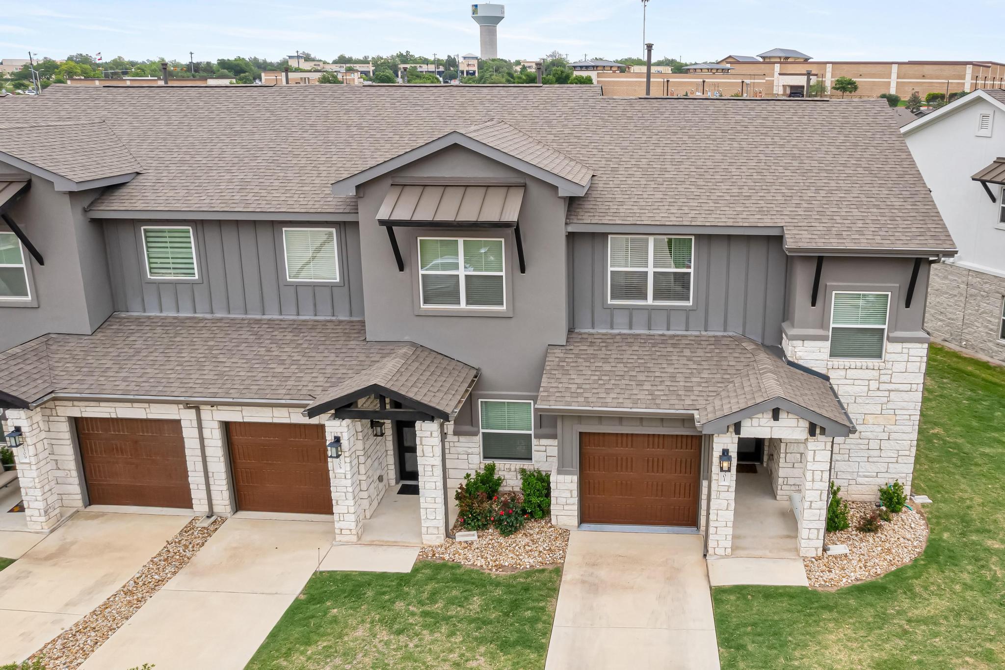 Textured stone veneer accents the exterior facade