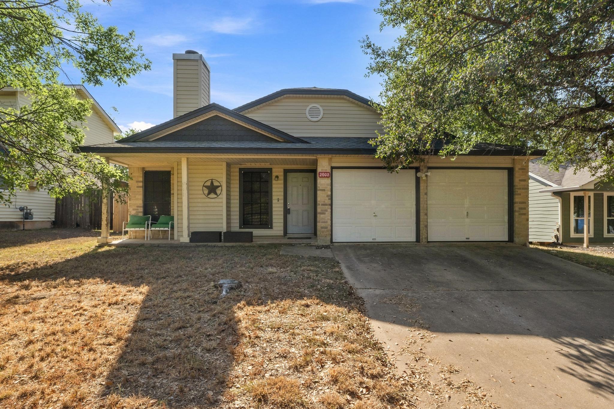 Mature trees shade a welcoming front porch and co