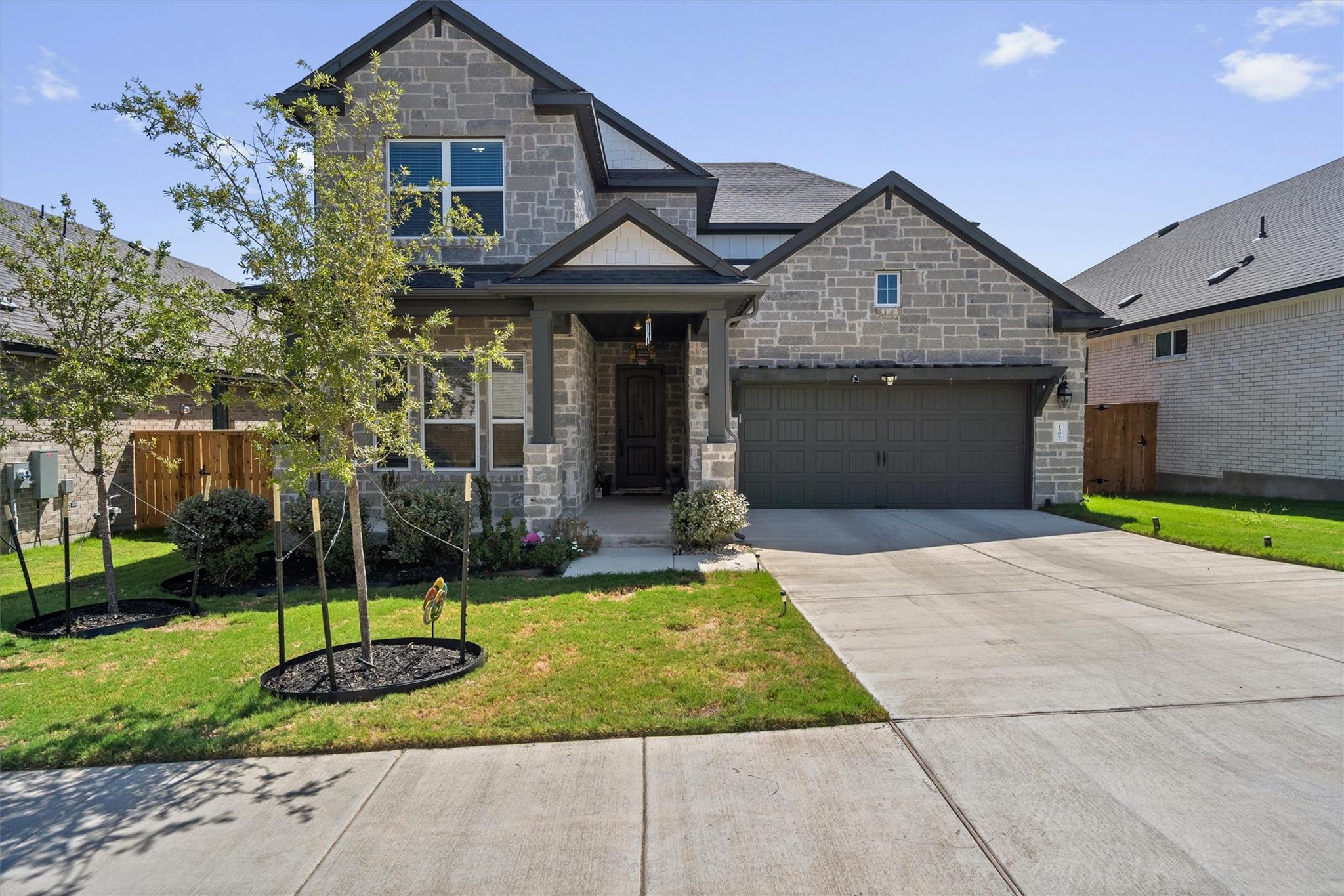 Textured stone veneer accents the exterior facade