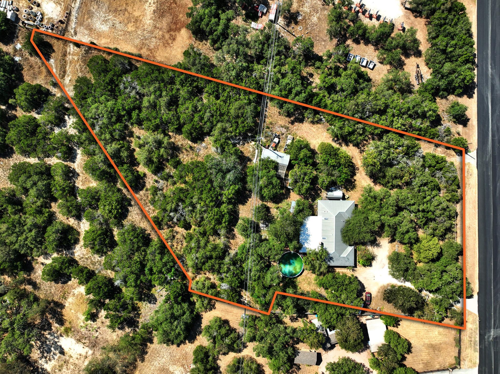 Mature trees surround the private acreage, outlin