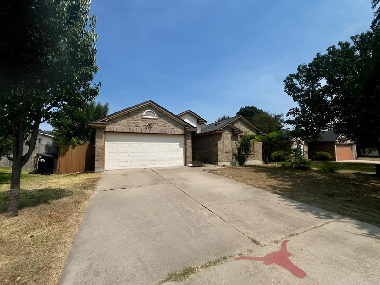 Classic brick exterior and a wide concrete drivew