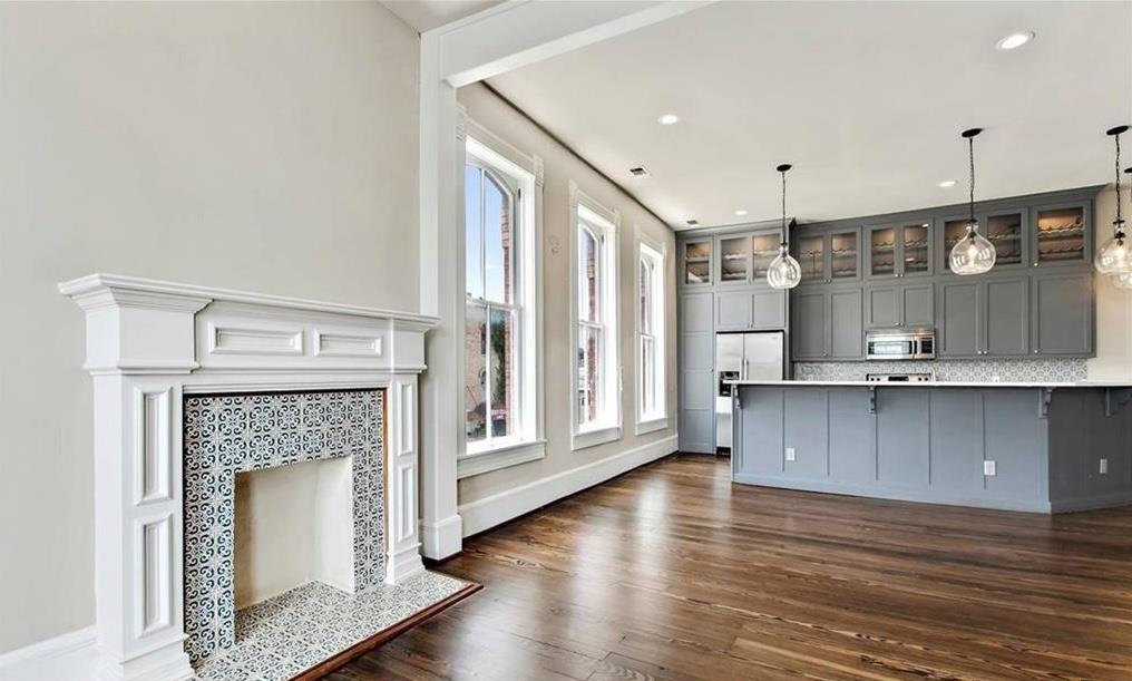 Rich hardwood floors sweep through an airy living