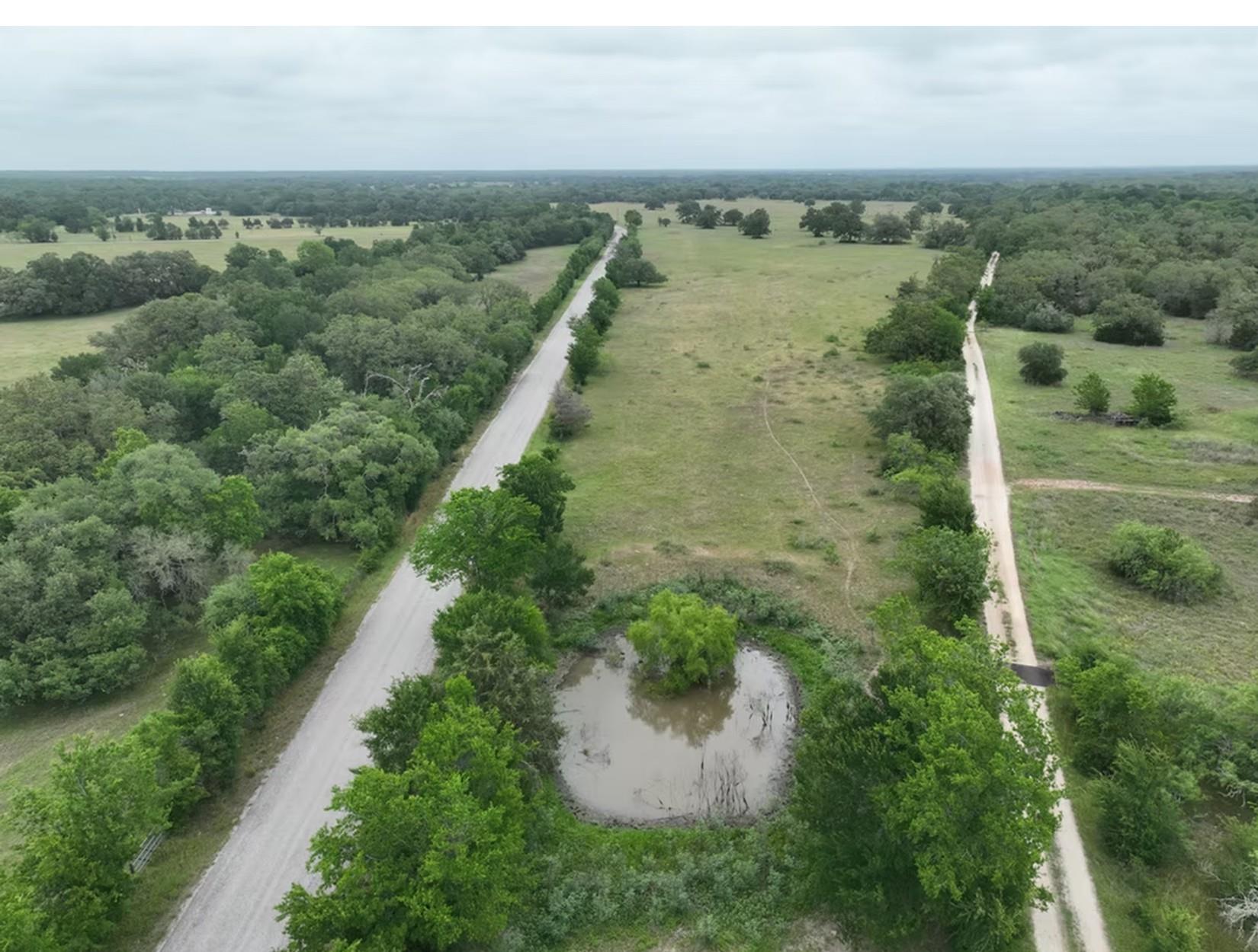 An aerial perspective showcases a private pond ne