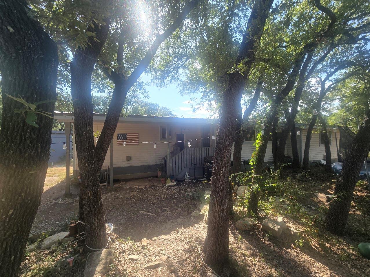 Mature trees shade the exterior of this single-st