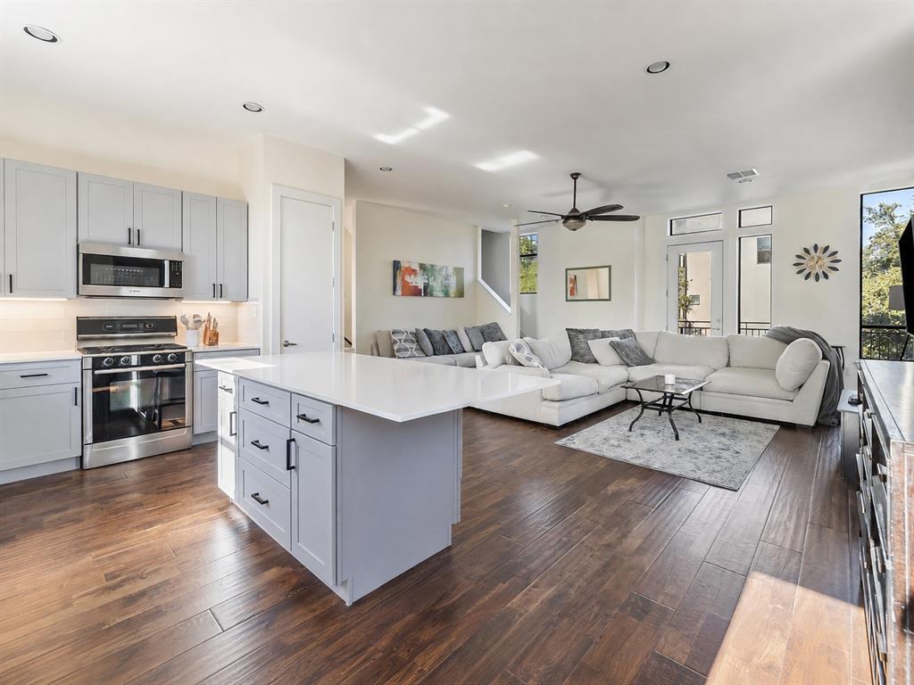 Rich wood floors anchor an airy open floorplan se