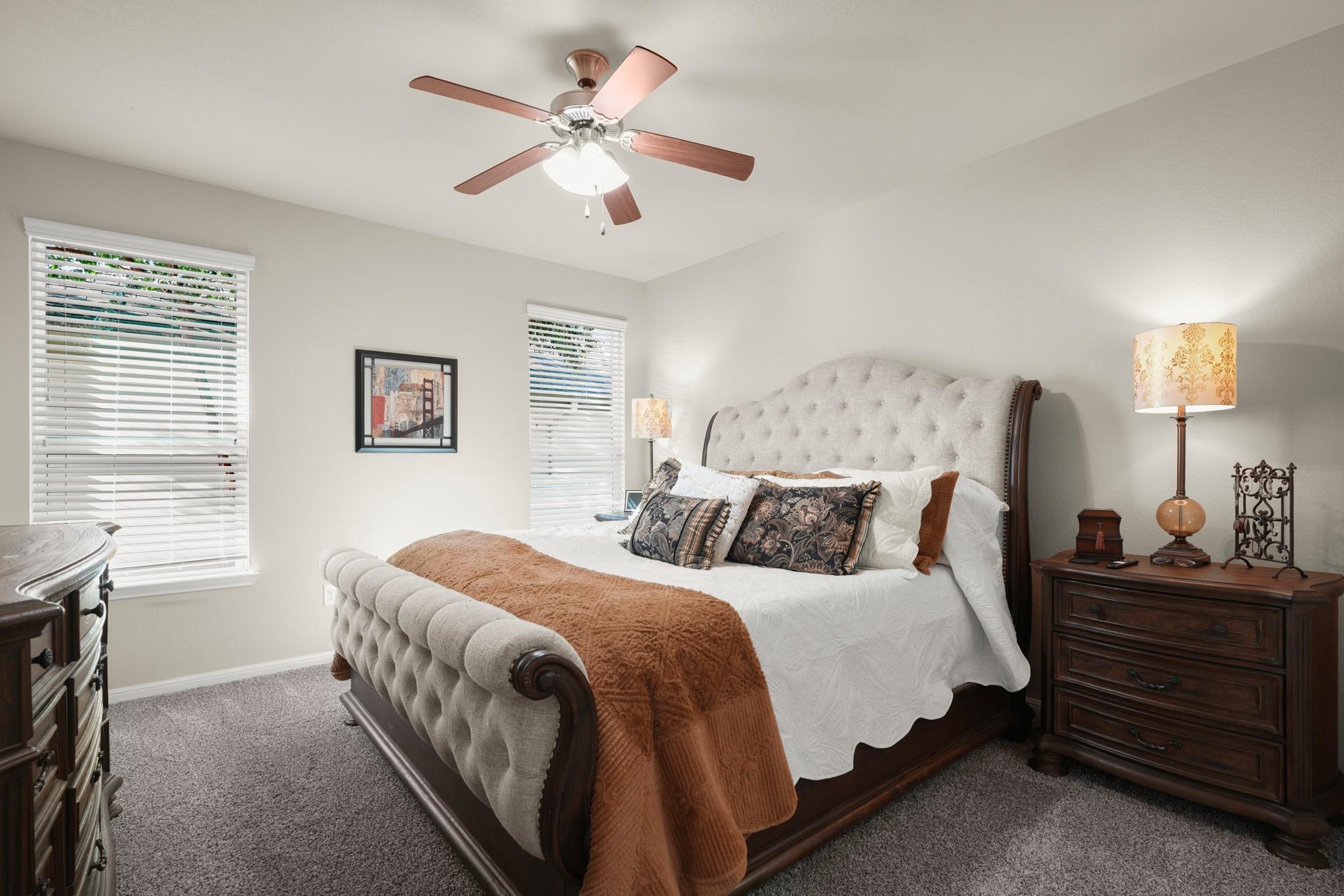 Plush carpet and large windows create a comfortab