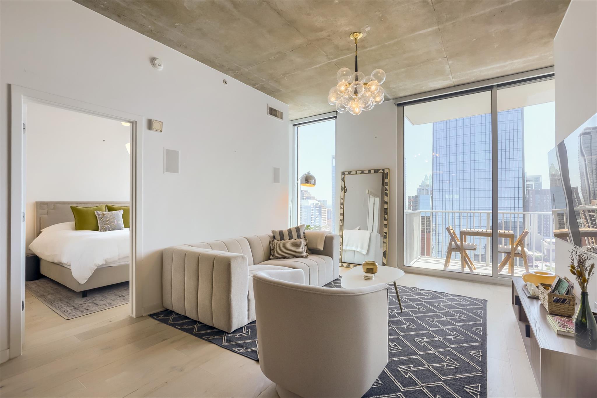 Floor-to-ceiling glass doors open to a private ba