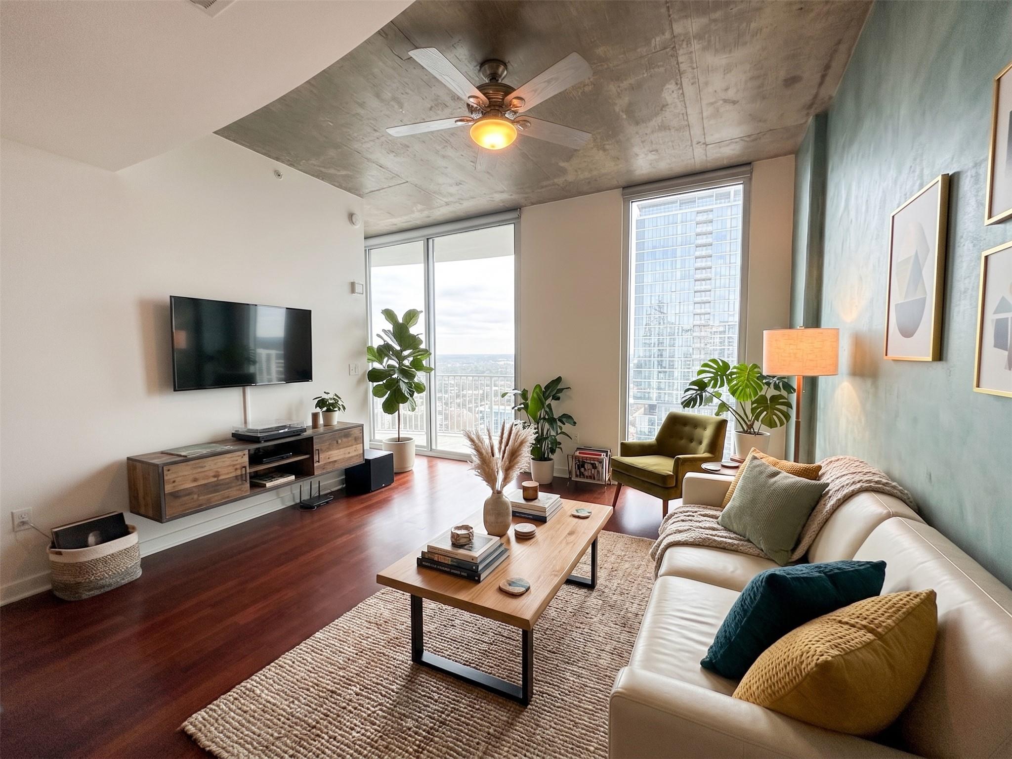 Floor-to-ceiling windows frame cityscape views in