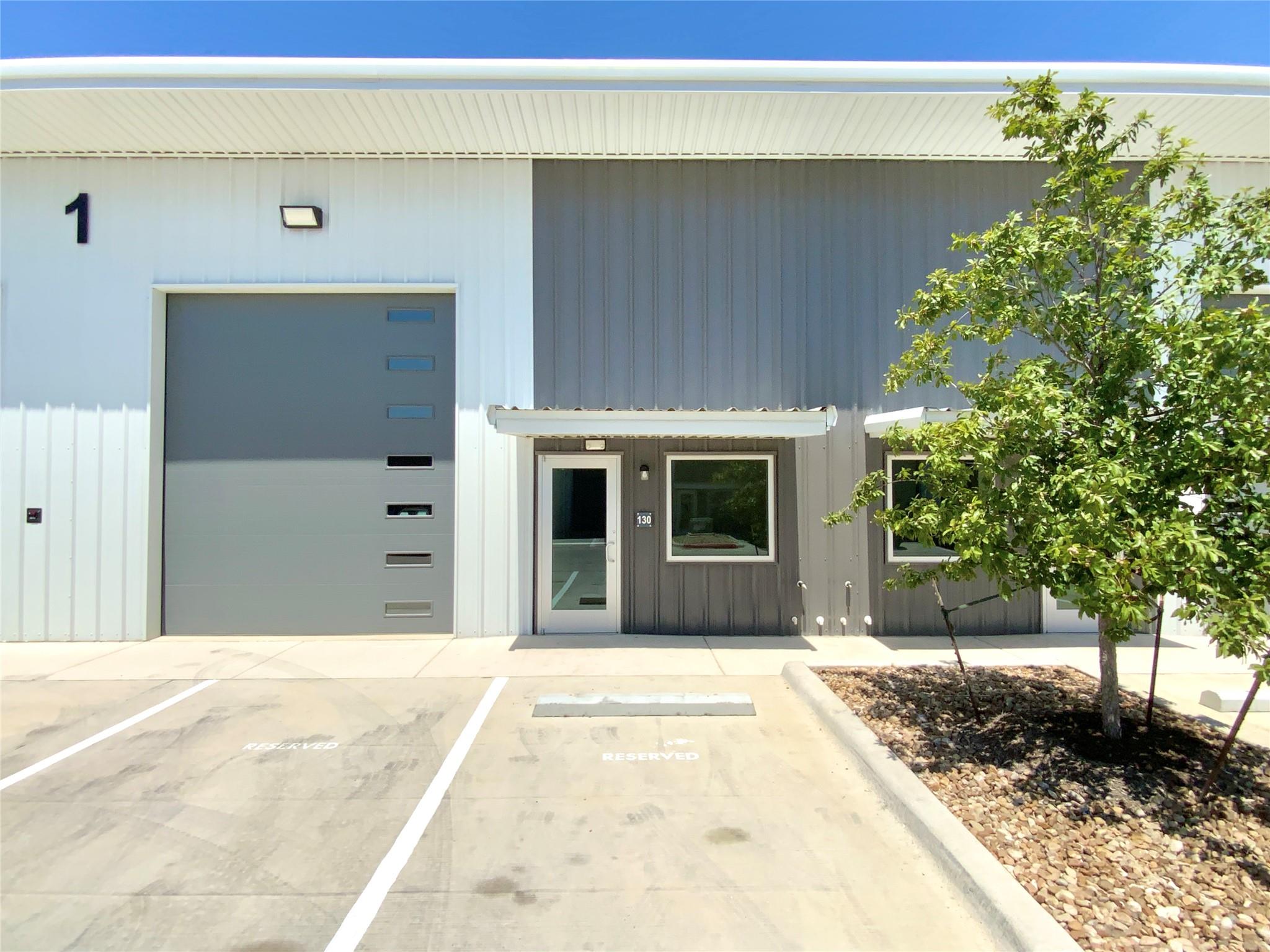 A modern metal-sided commercial facility features