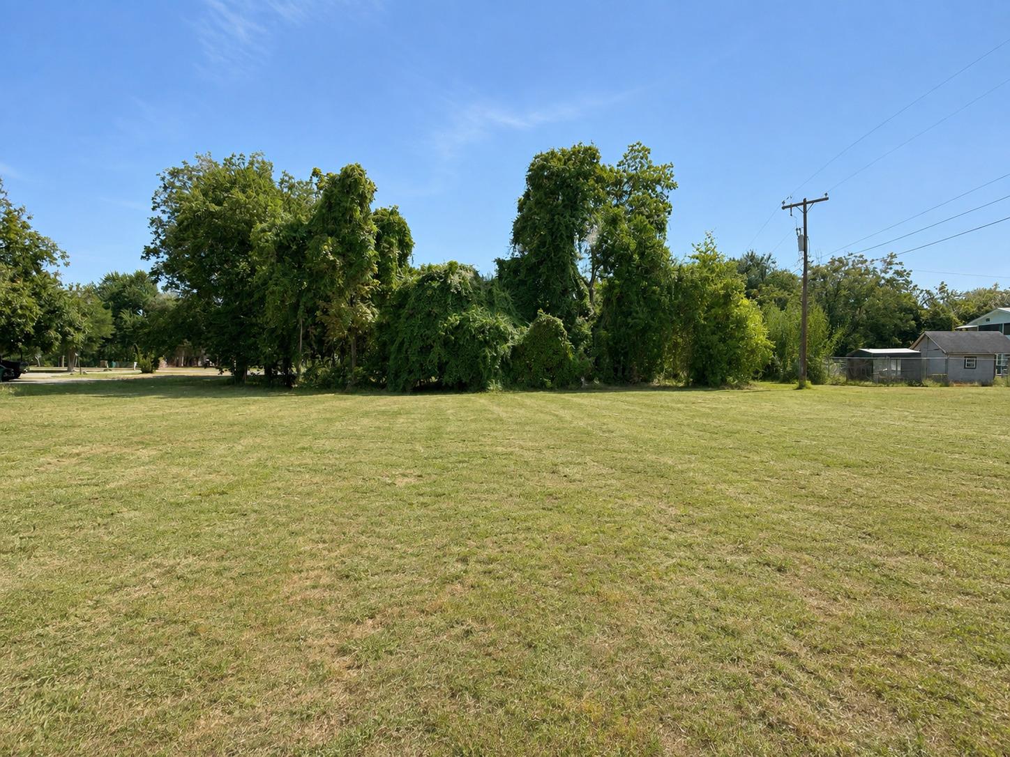 A spacious grassy lot provides ample open space b