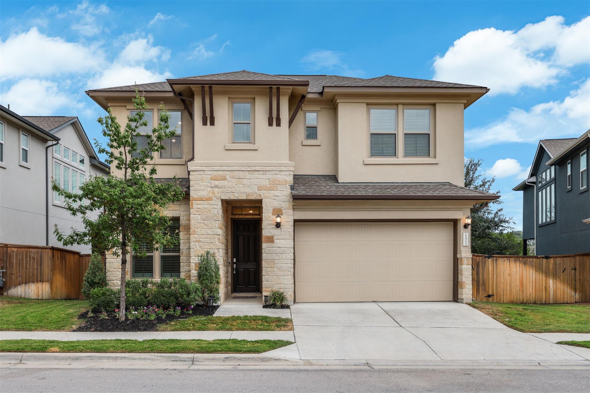 An inviting stone and stucco exterior anchors thi