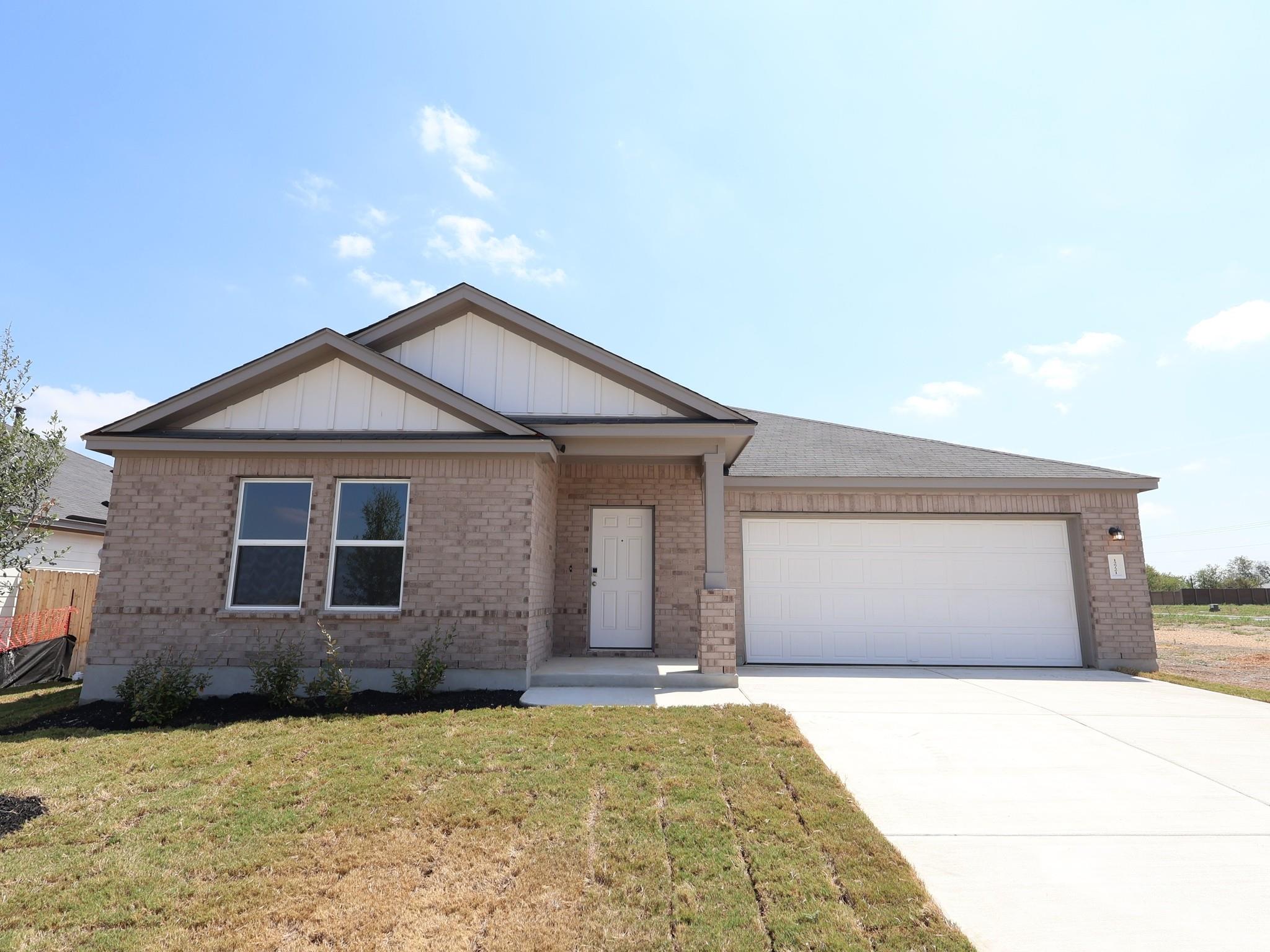 Brick cladding and gabled rooflines create classi