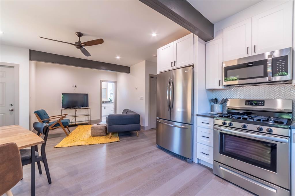 Exposed support beams and smooth wood flooring de