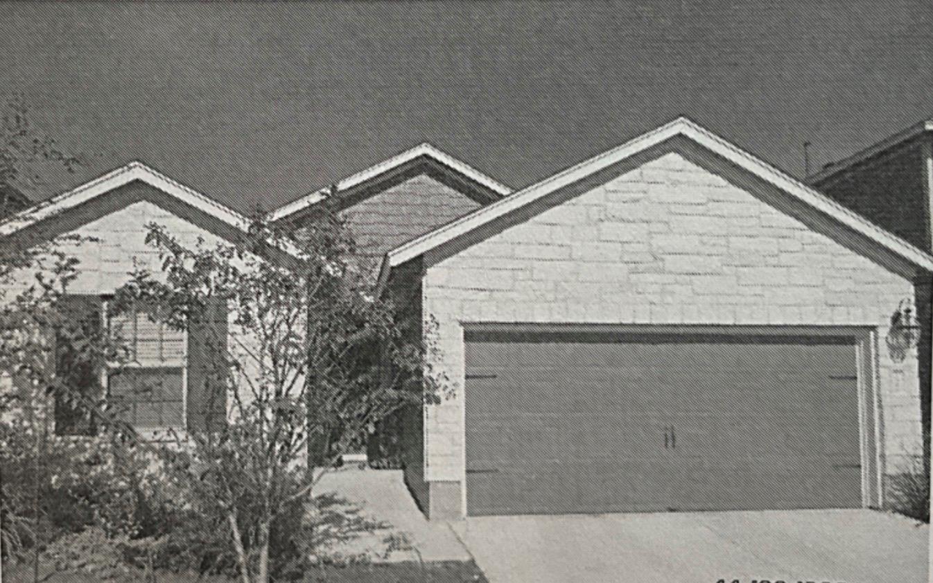 Textured stone veneer accents the gabled front ex