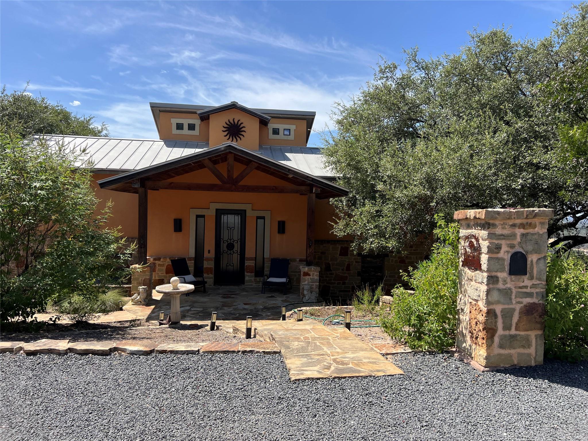 A stone pathway leads to the covered front porch 