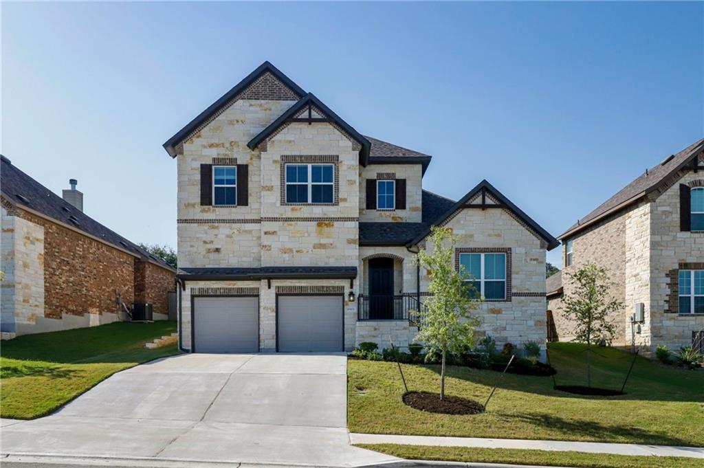 Natural stone masonry and a wide concrete drivewa