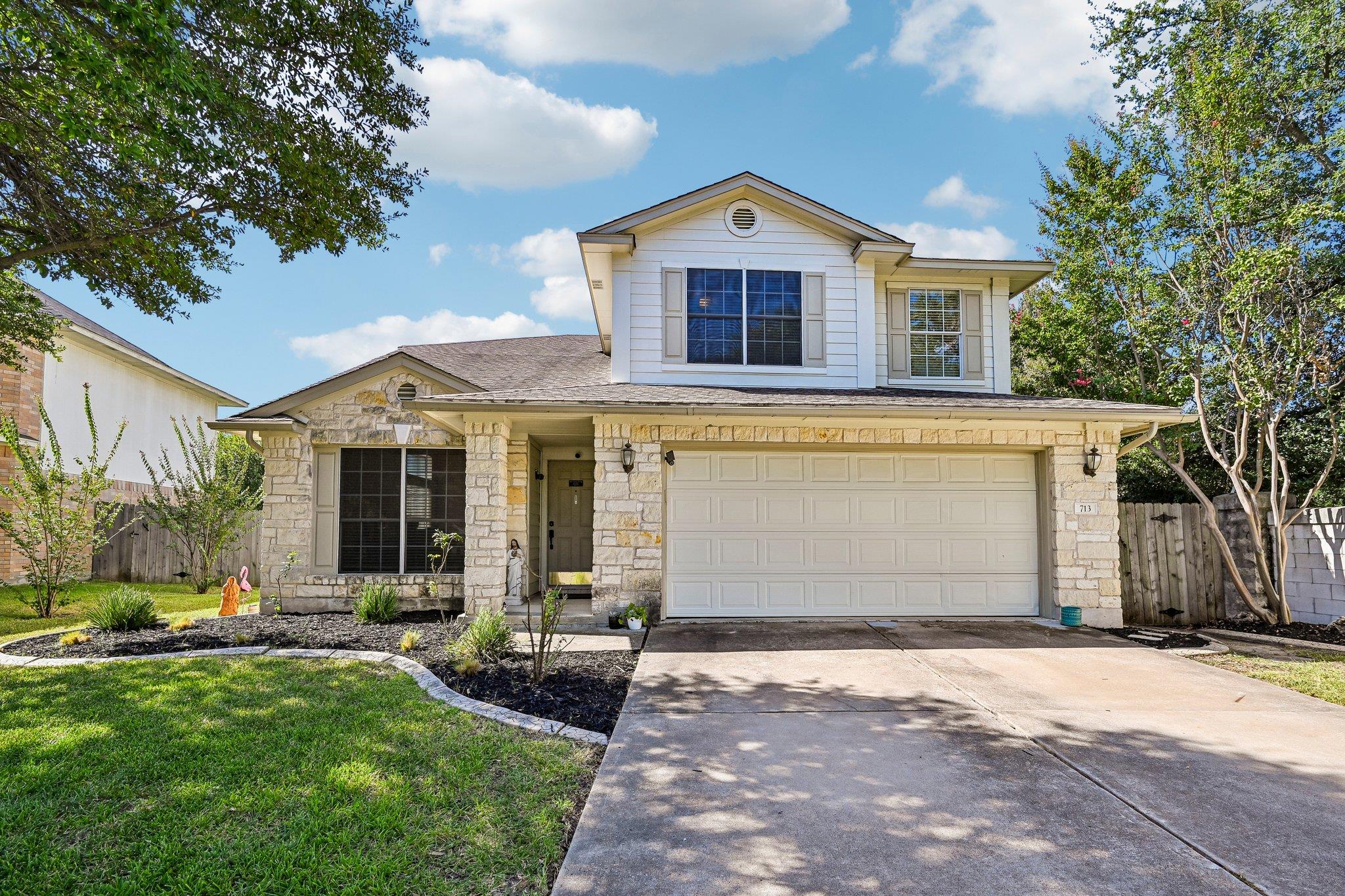 Limestone and siding wrap this two-story exterior