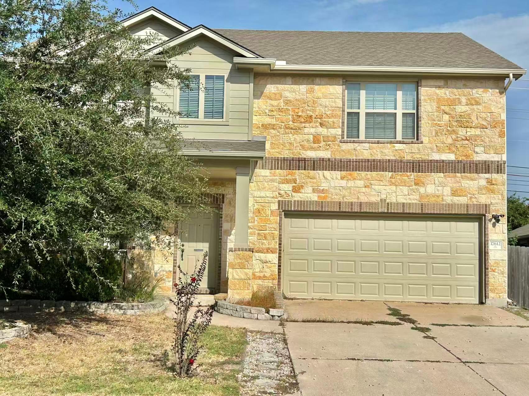 Natural stone and siding define the exterior of t