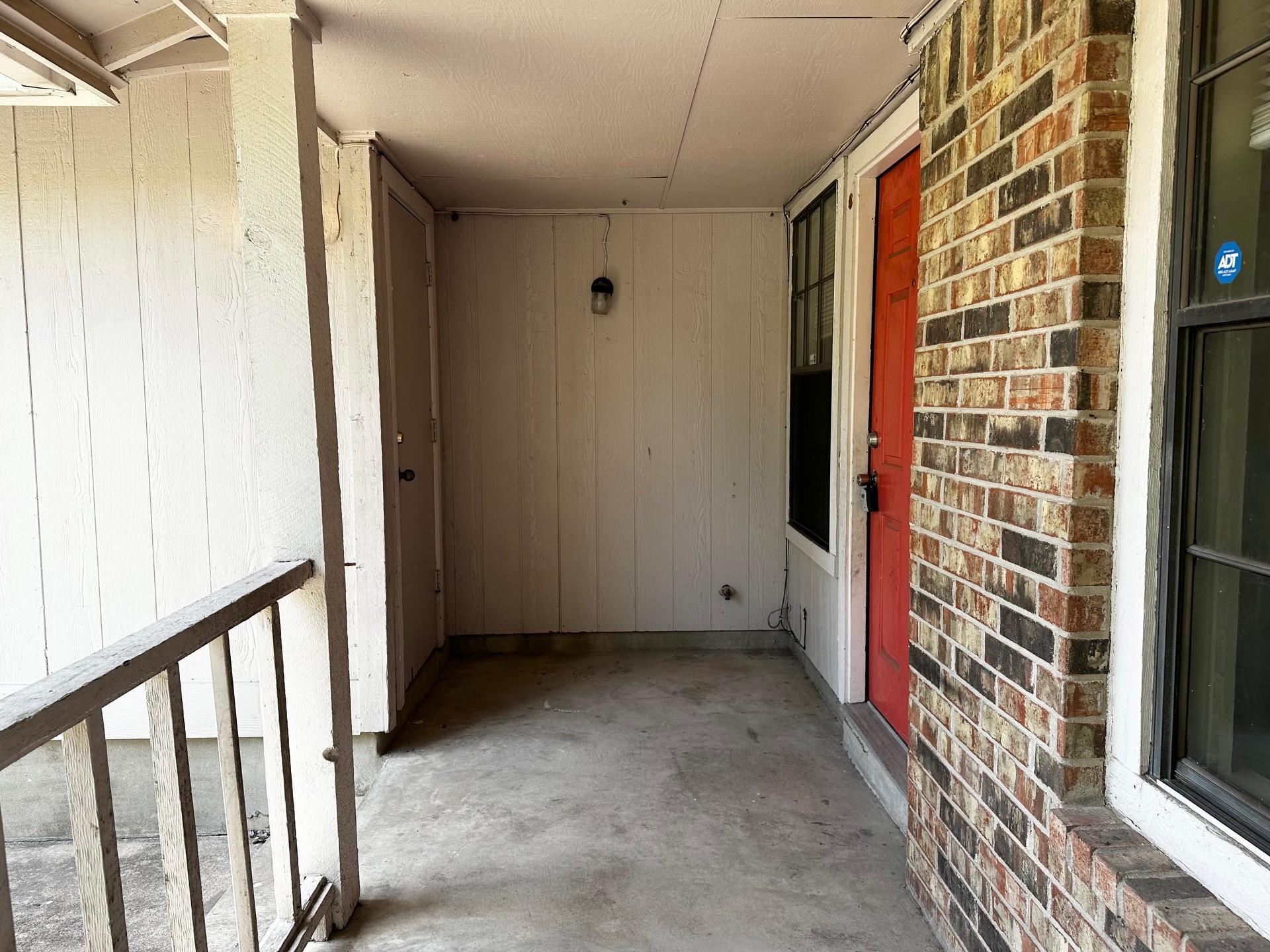An inviting covered entryway welcomes visitors wi