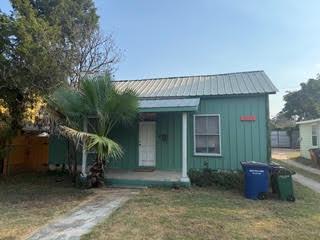 A quaint front porch welcomes visitors to this cl