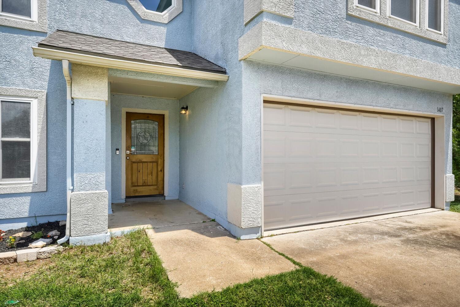 A classic stucco exterior is paired with a wooden