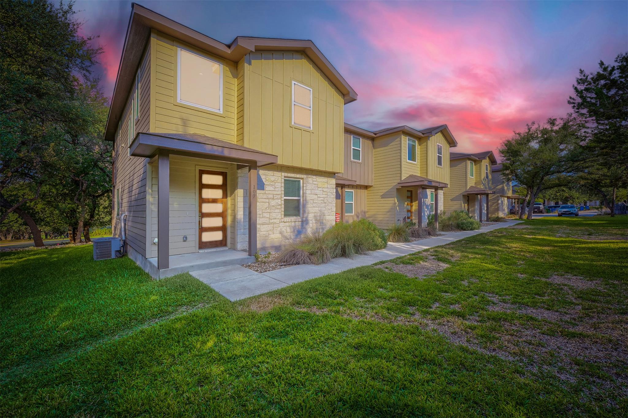 Multi-level townhomes showcase mixed siding, ston