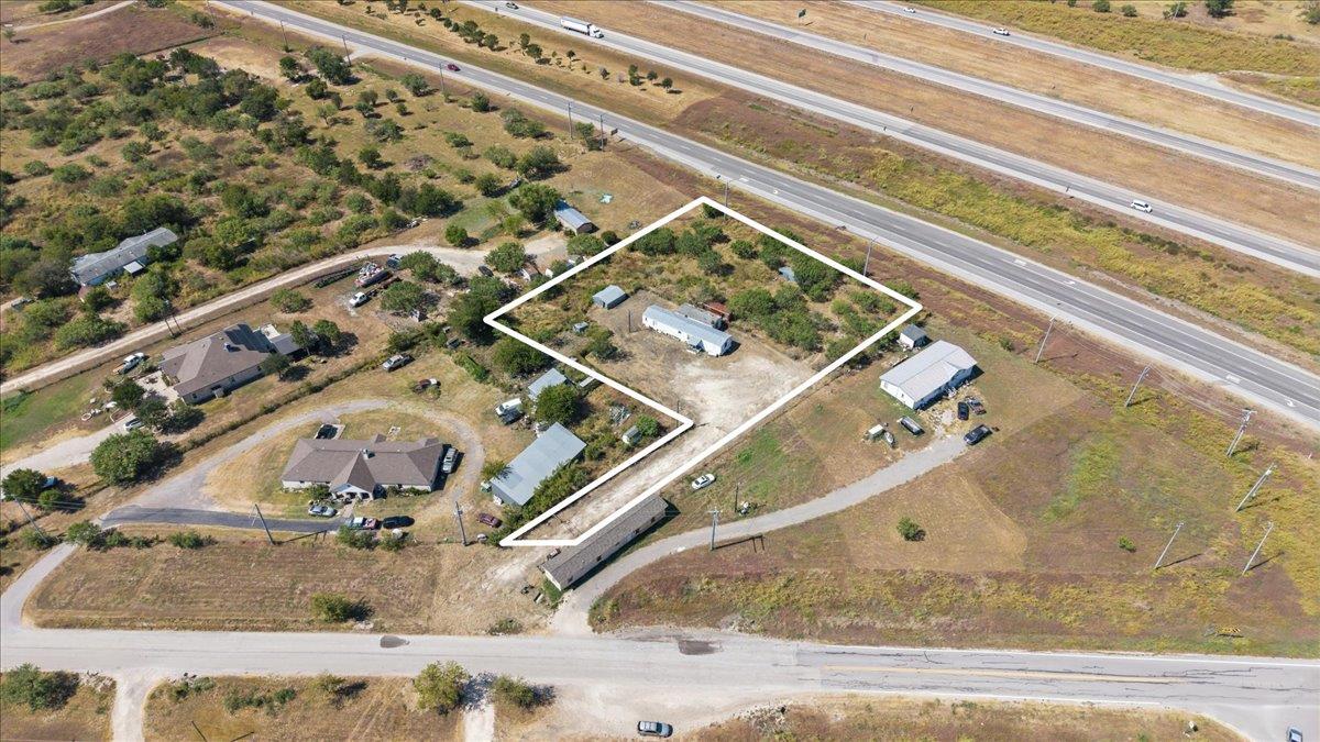 An aerial perspective showcases a spacious rural 
