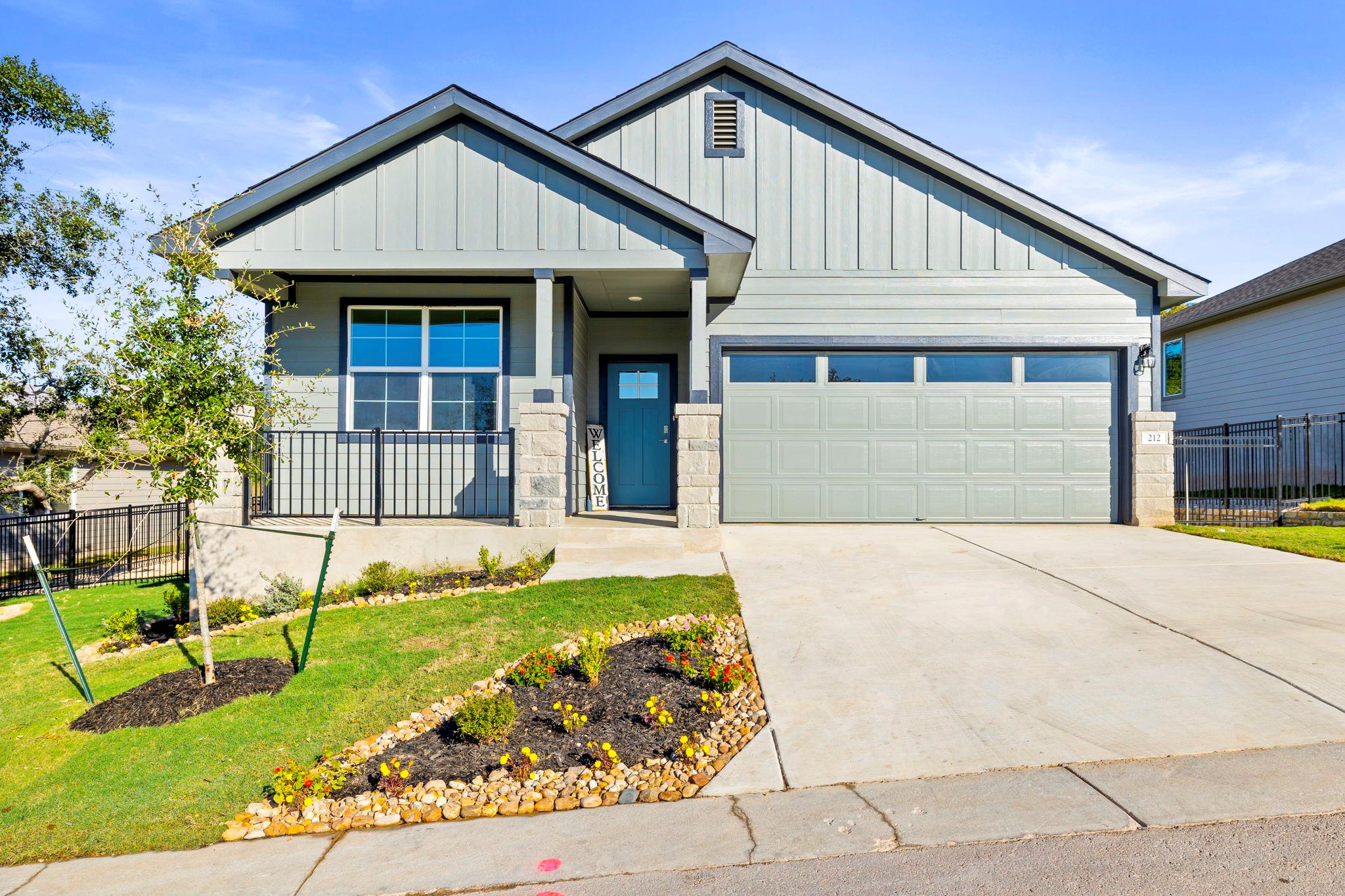 Crisp vertical siding paired with stone accents d