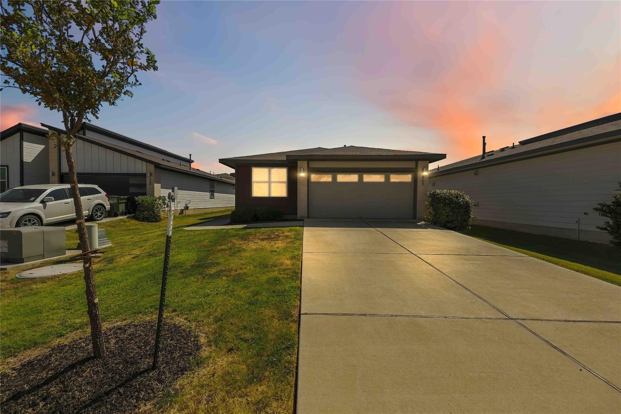 A spacious concrete driveway leads directly to a 