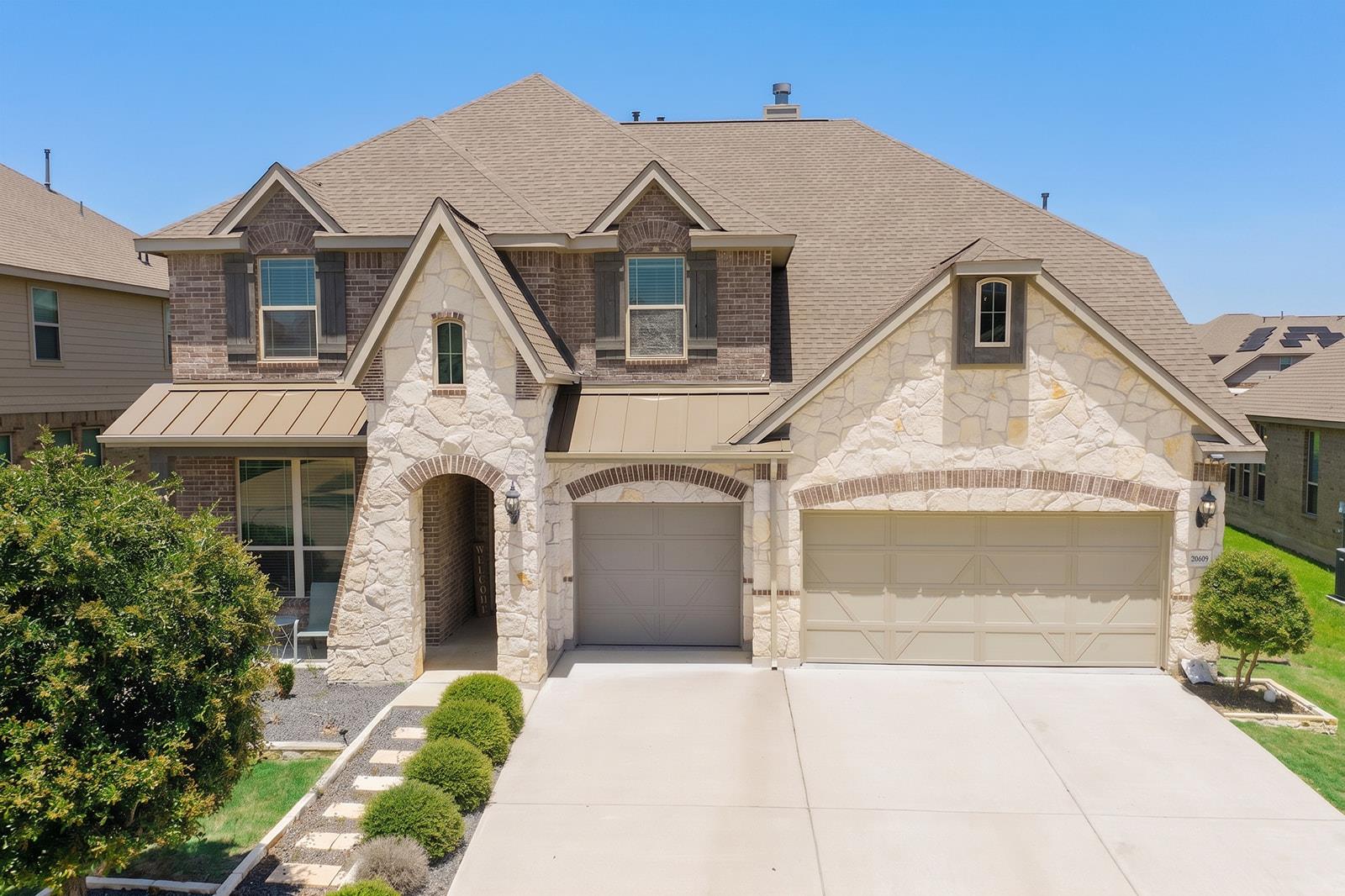 Multi-textured stone and brick exterior accents a