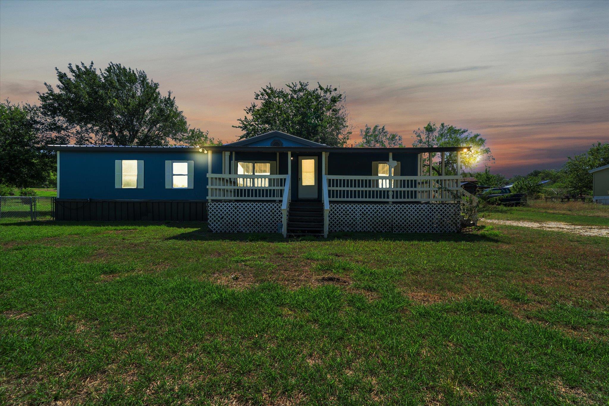 A spacious covered front porch spans the facade o