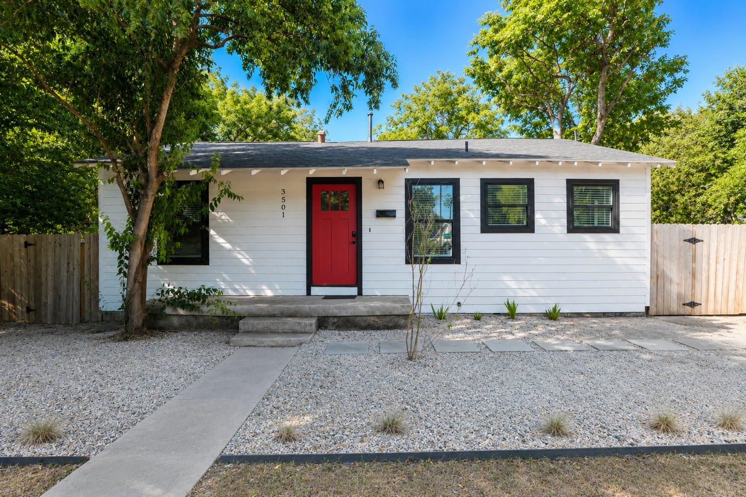 Crisp siding and a bold front door establish deli