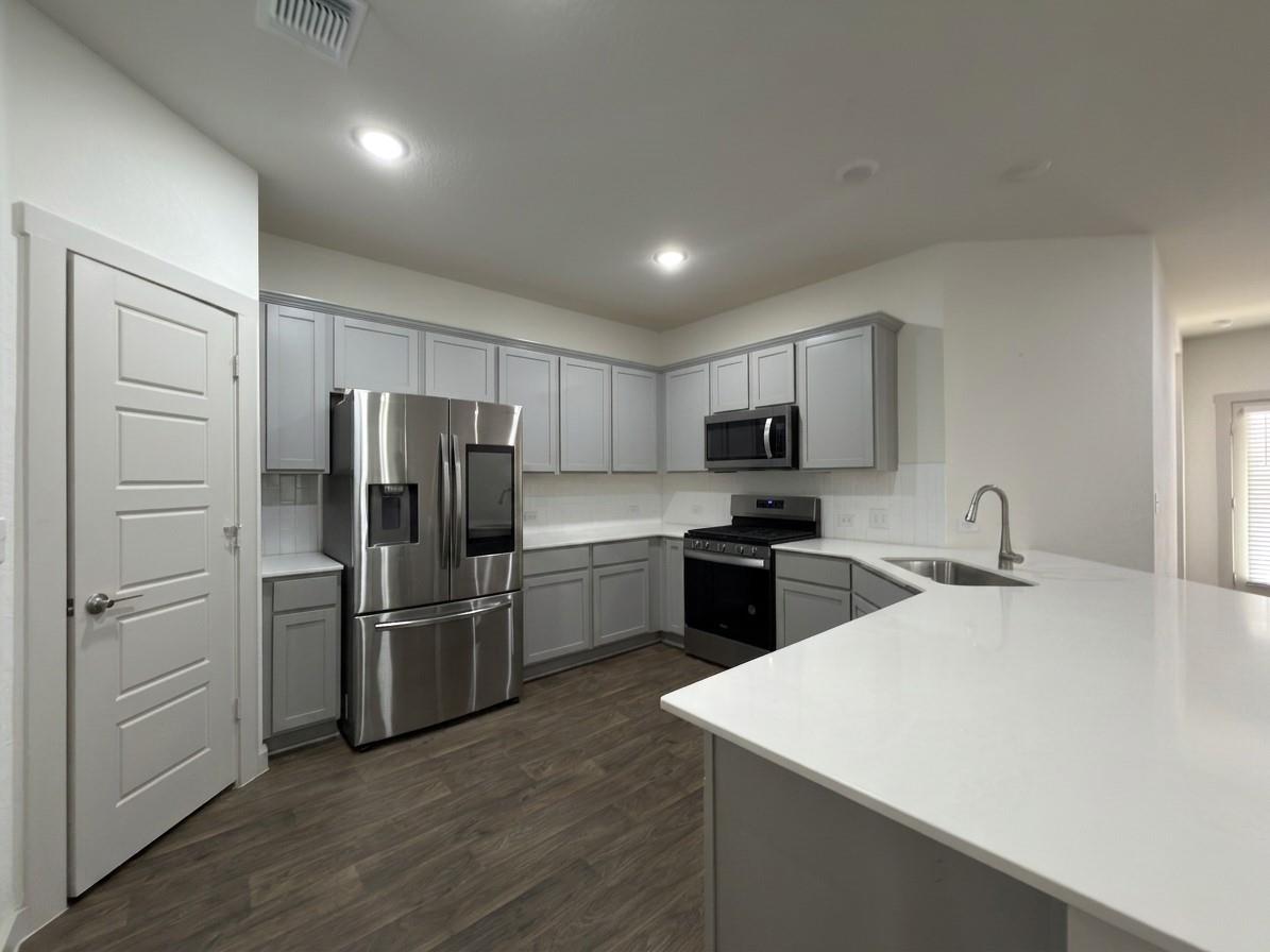 Gleaming stone countertops and stainless steel ap