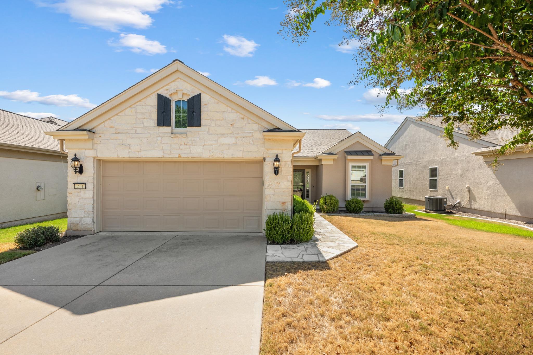Limestone and stucco exterior details accent this