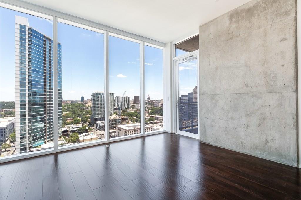 Expansive floor-to-ceiling windows frame the city