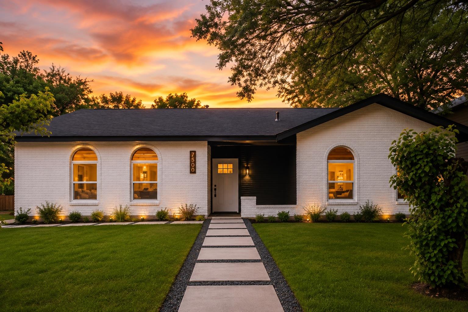 Arched windows and painted brick siding define th