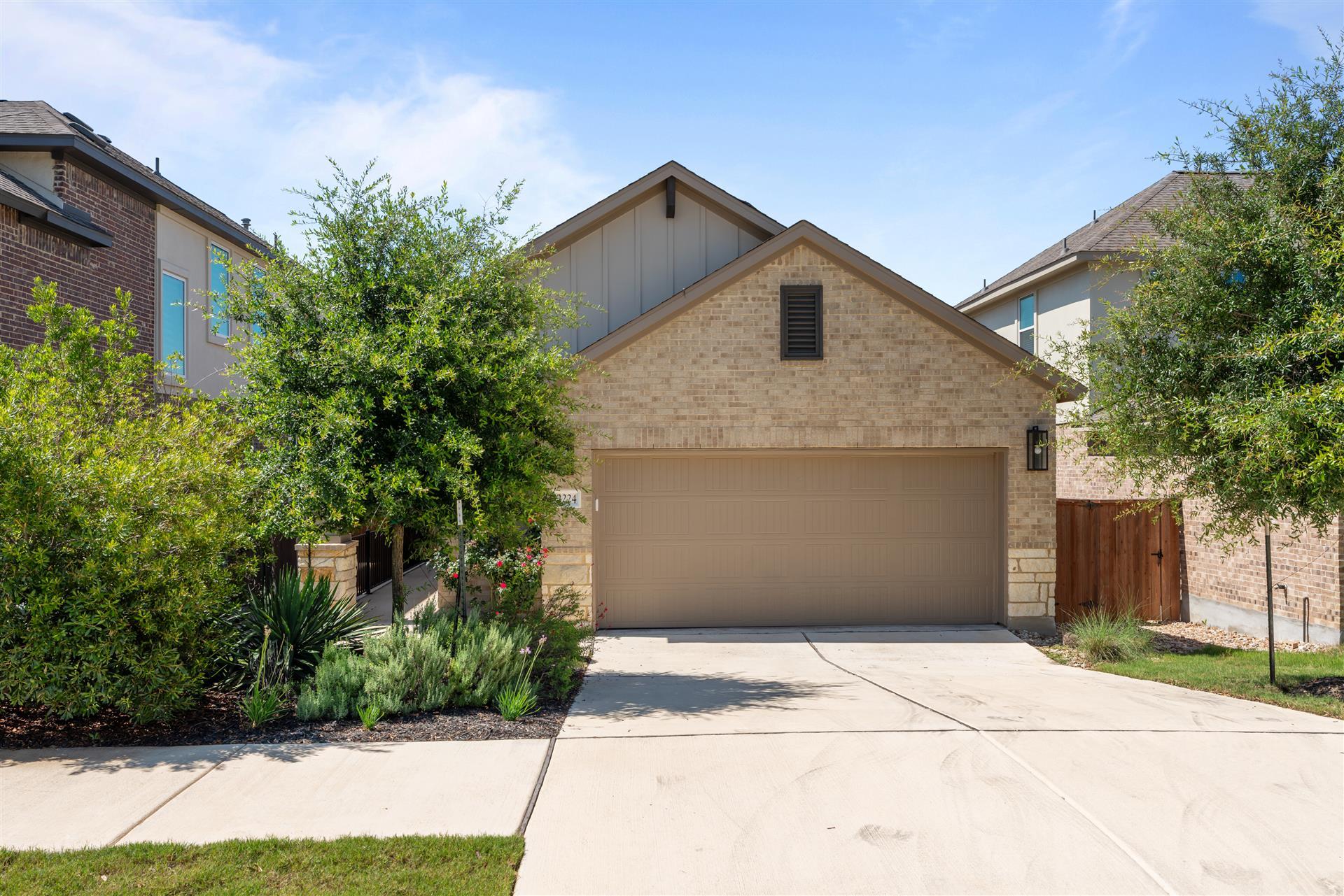 An inviting stone and siding facade defines this 