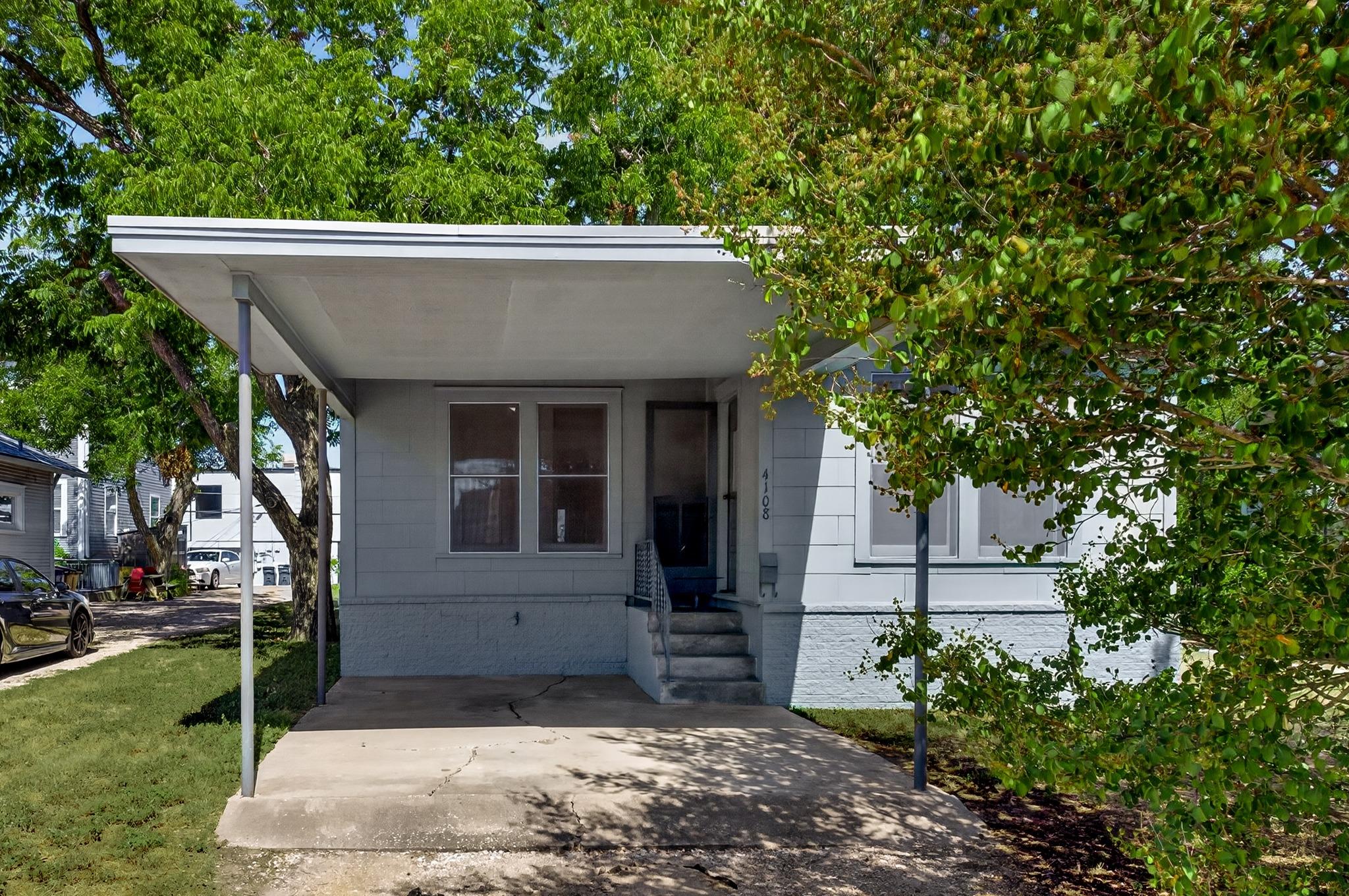 A deep covered carport protects the entry stairs 