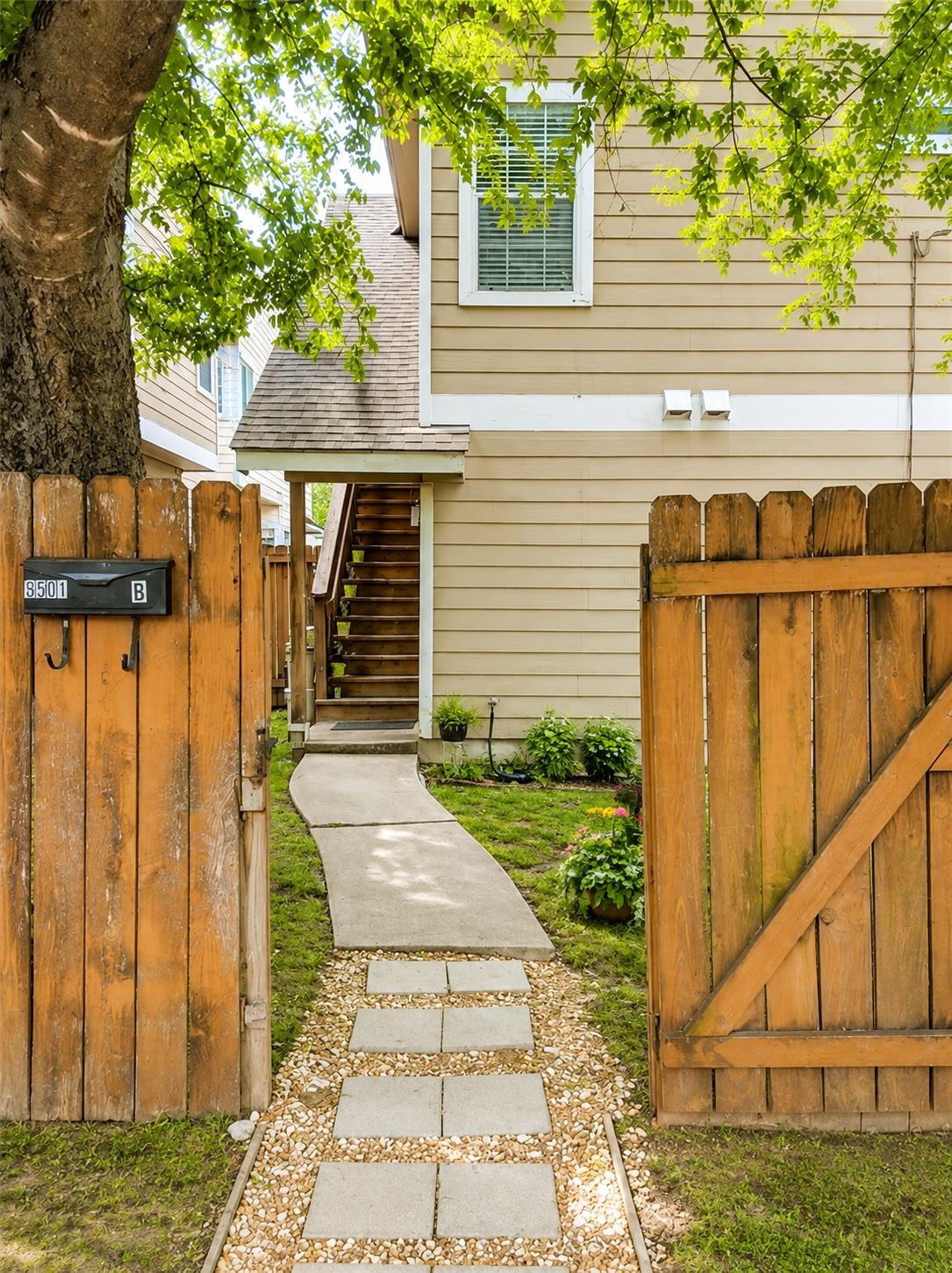 A welcoming stone pathway leads past the wooden p