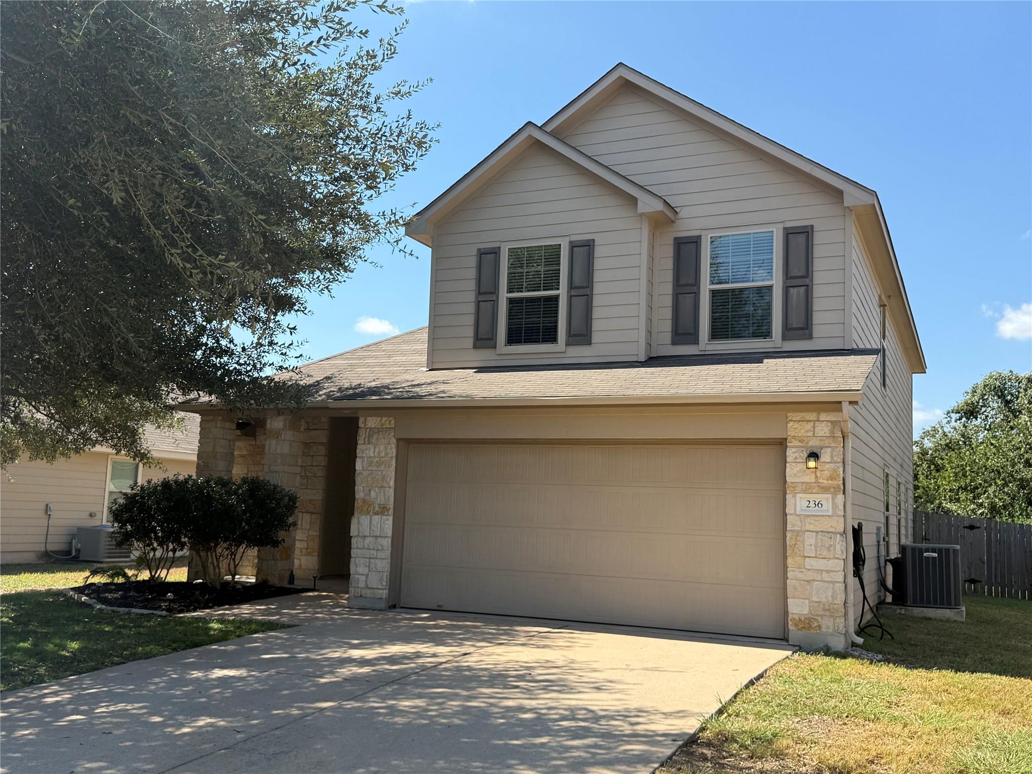 Stone accents and horizontal siding define this m