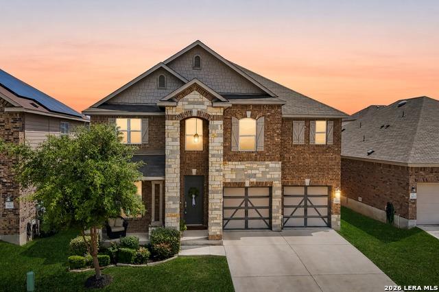 Textured brick and stone masonry defines this mul
