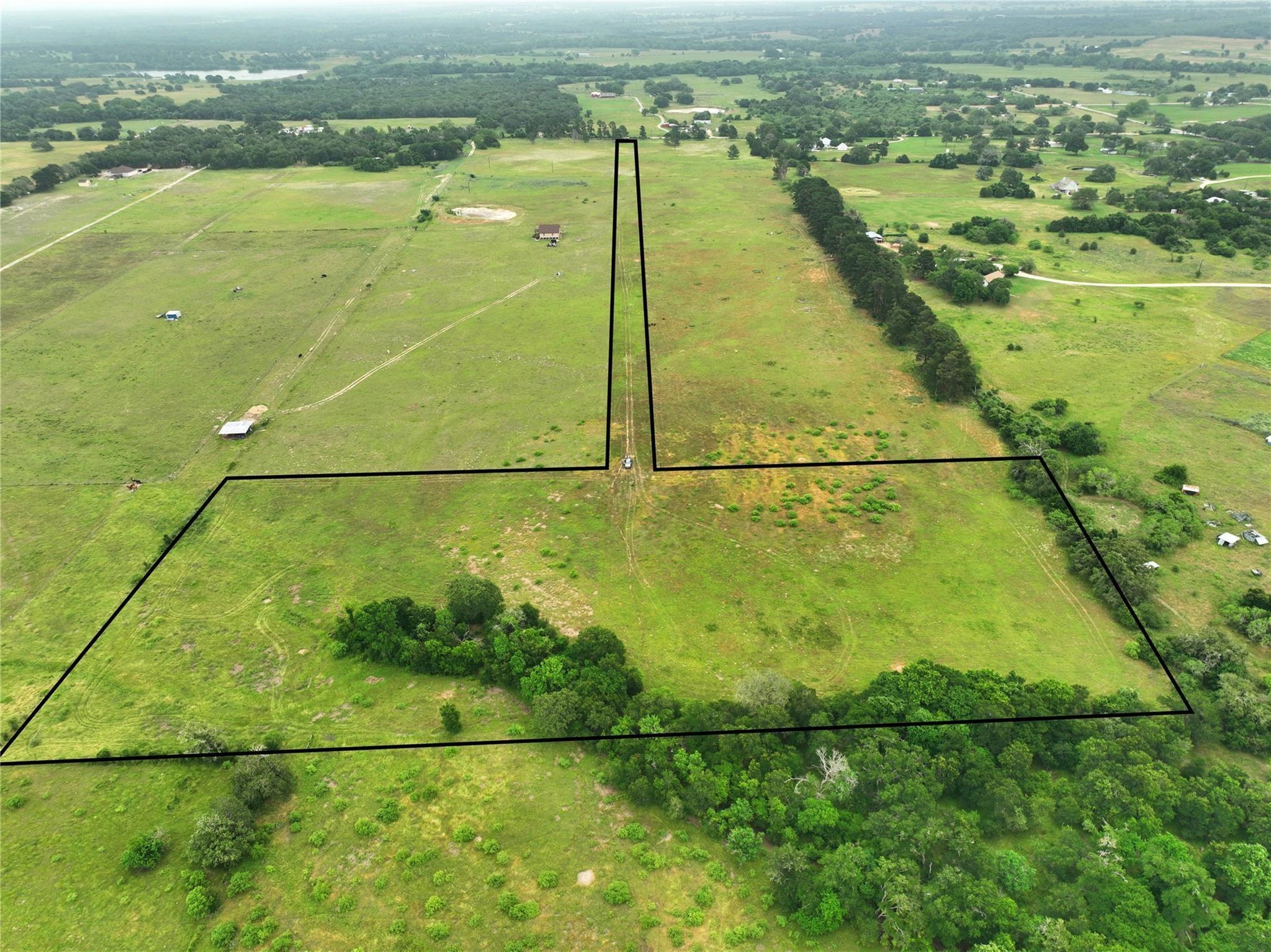 Lush green pastures and mature trees outline this