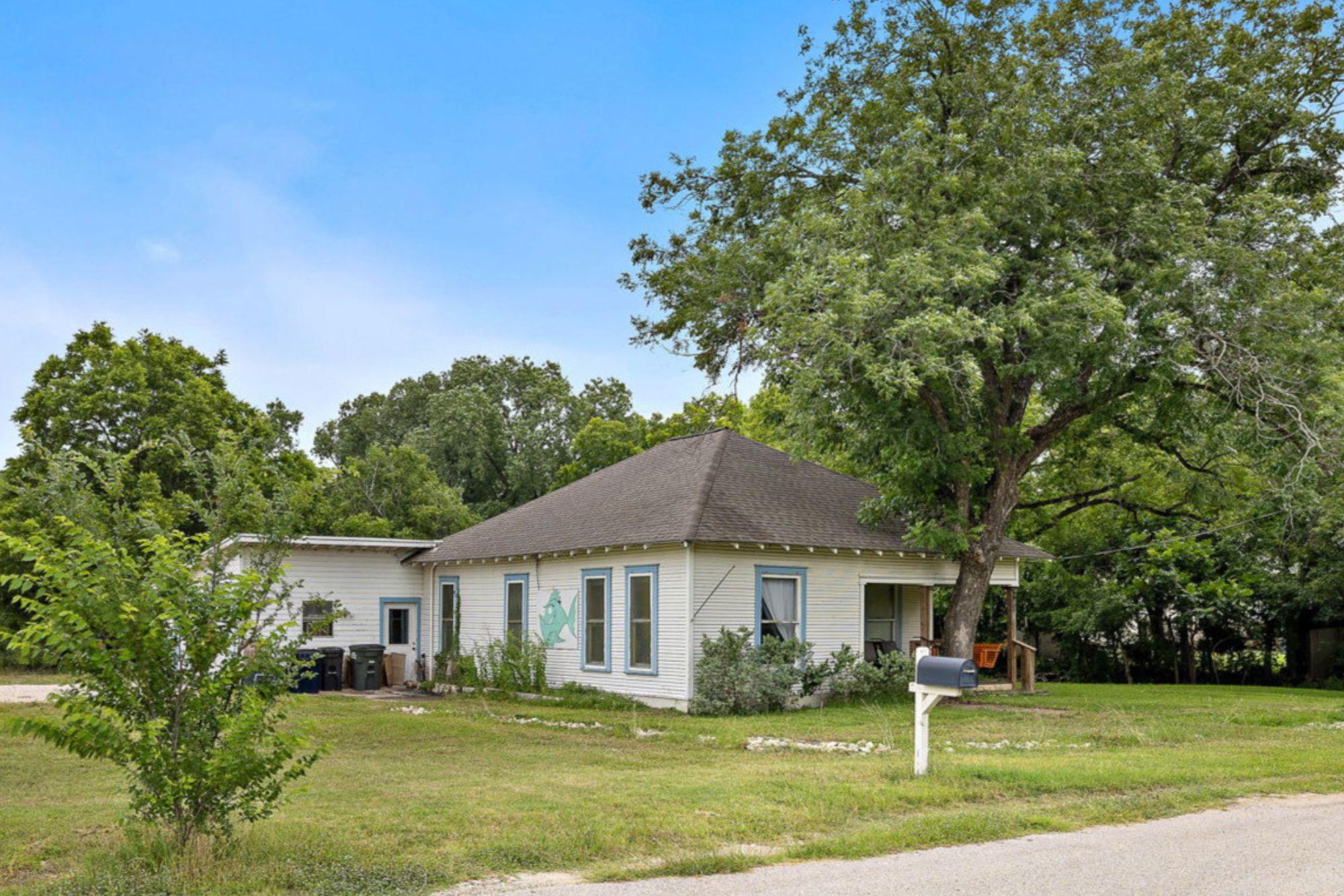 Mature trees shade this classic single-story home