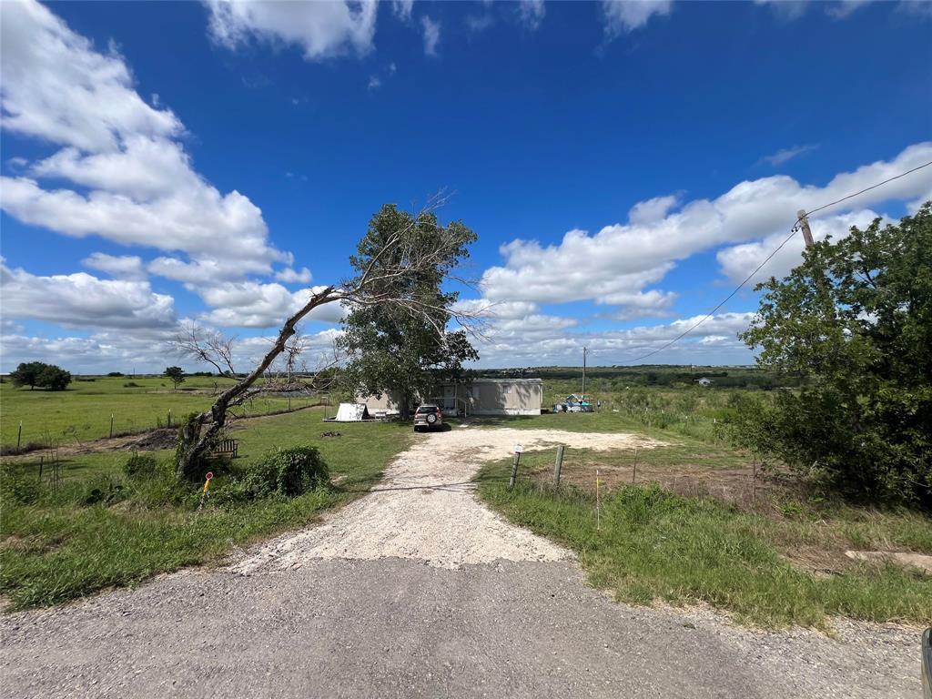 An gravel driveway leads to the property surround